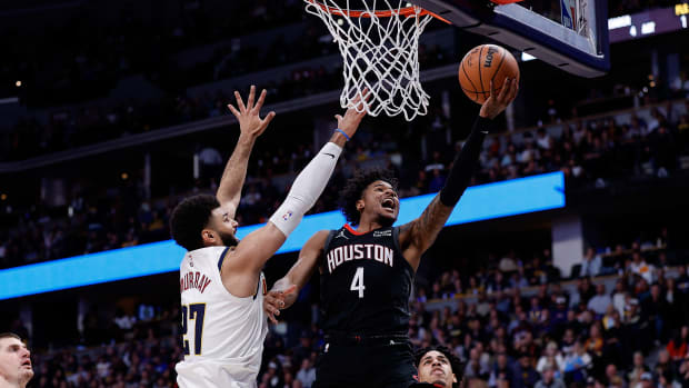Rockets guard Jalen Green drives to the net against Denver Nuggets guard Jamal Murray (27) in the second quarter at Ball Arena.